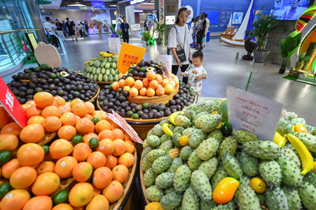  woman and her child shop for African fruits